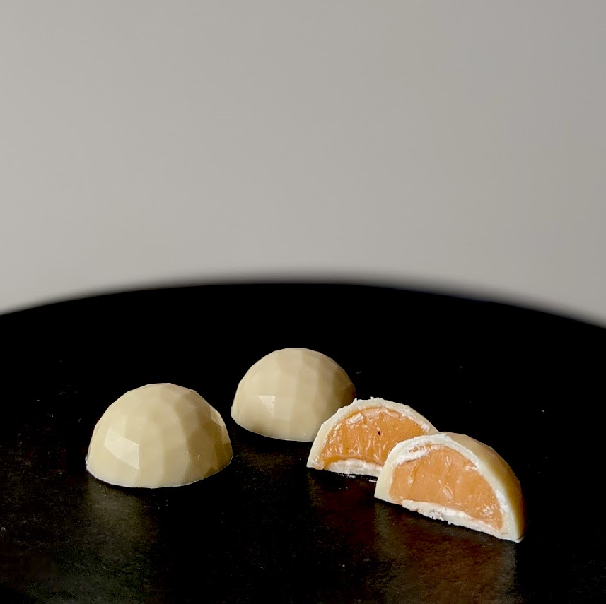 White chocolate bon bons filled with a Thai tea ganache